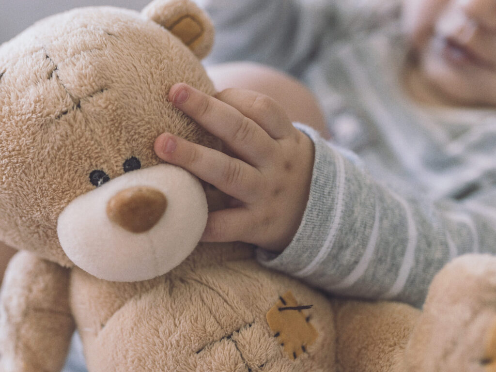 Baby Hands Holding A Teddy Bear.