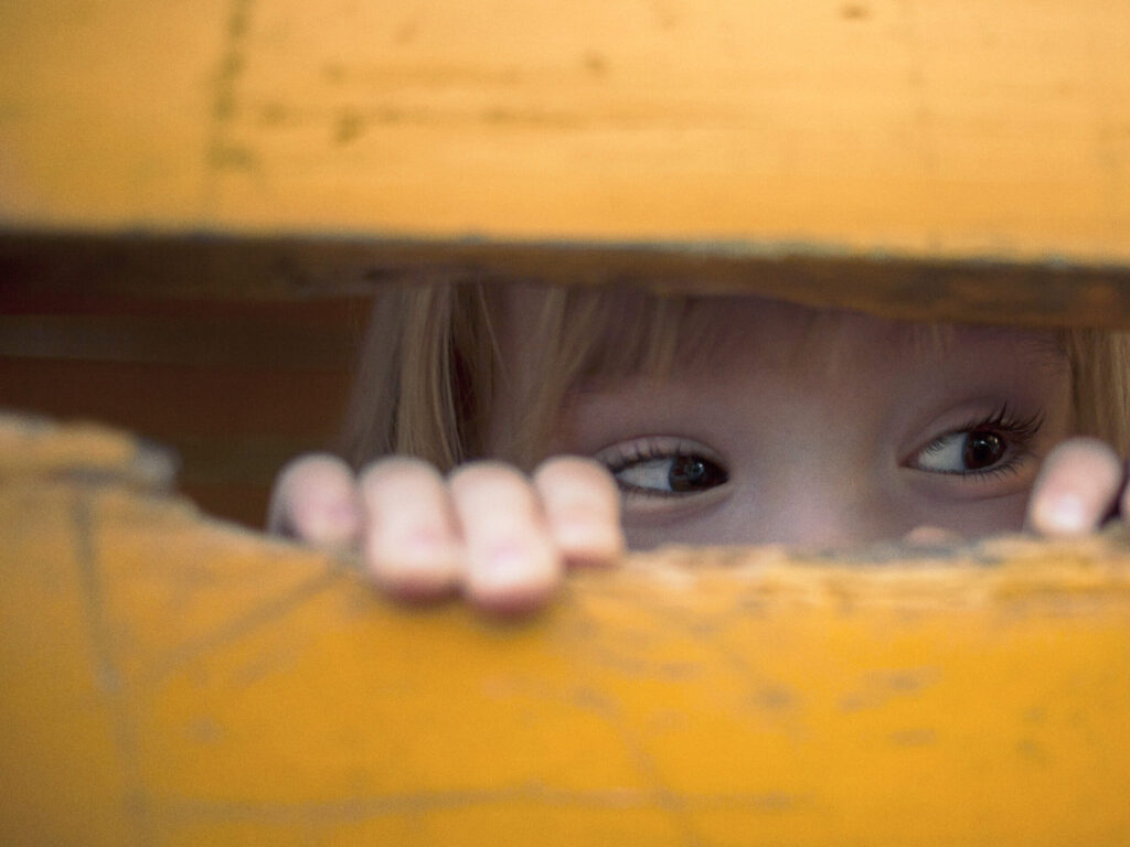 Little Child Peeking At Playground