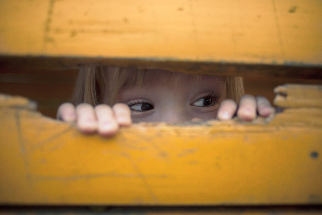 Little child peeking at playground